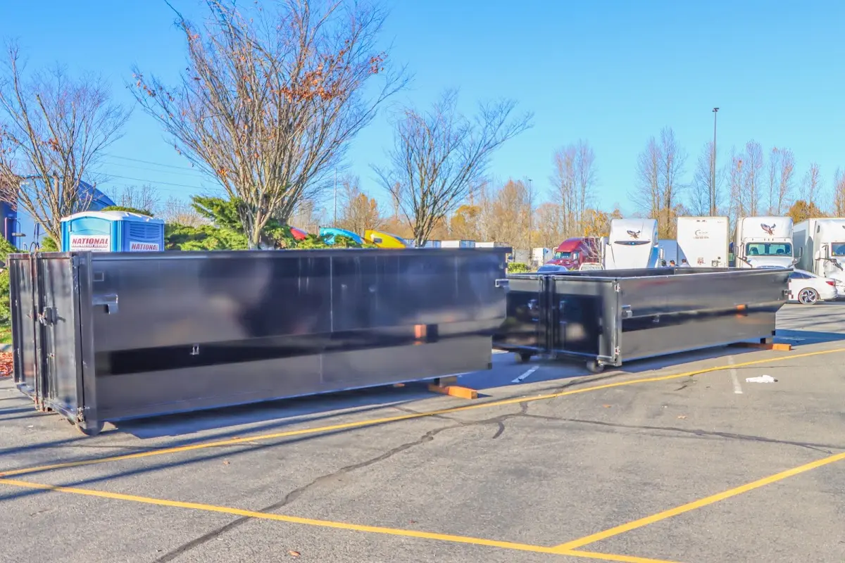 Professional dumpster rental service with roll-off container on residential driveway in Winona